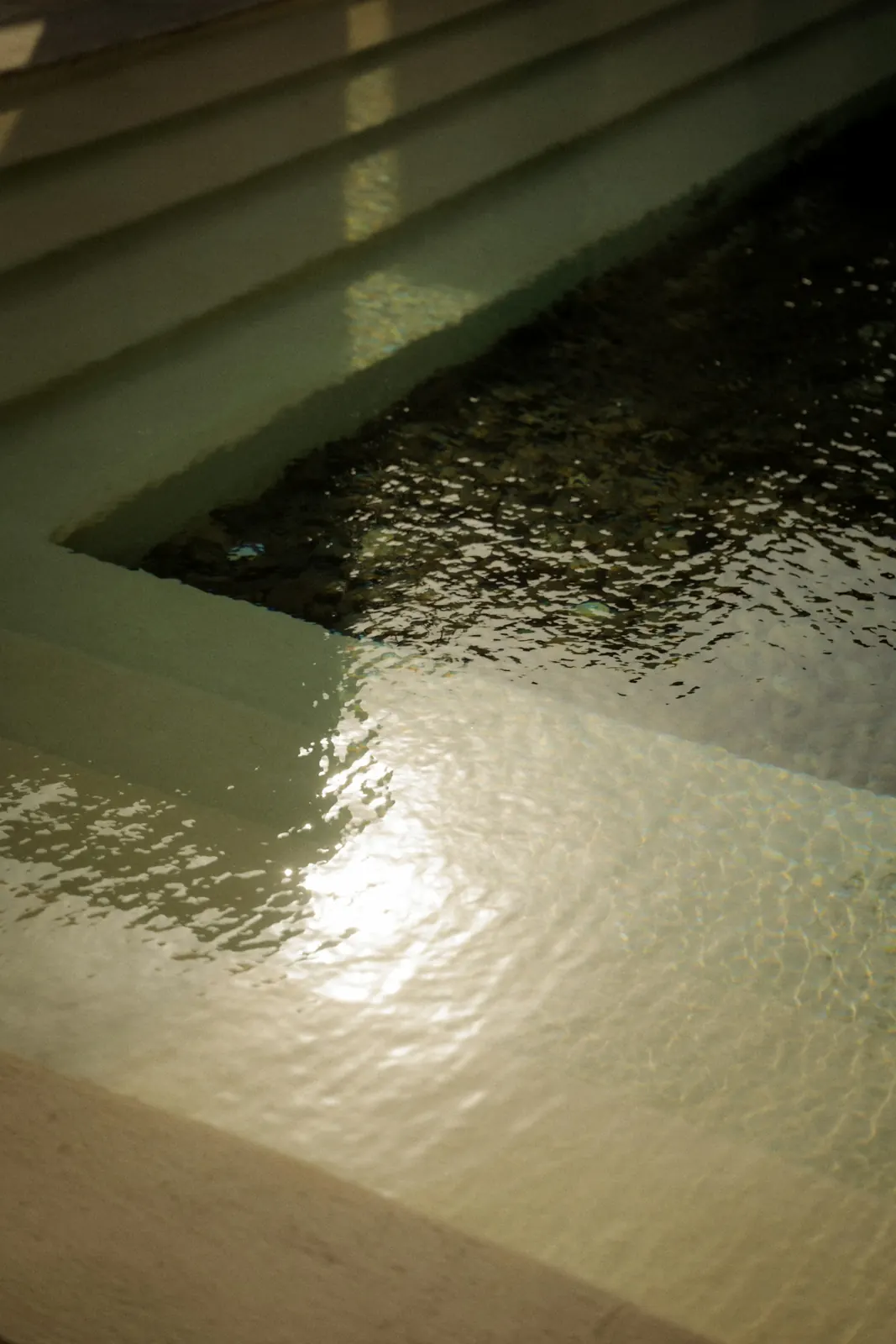 Sunlight on rippling water in a pool